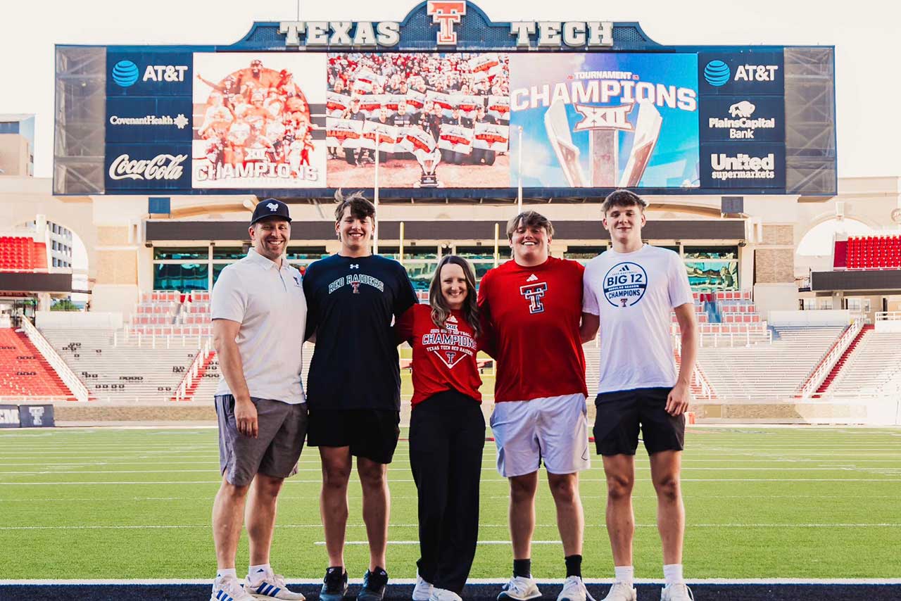 Athletic family at football stadium with scoreboard
