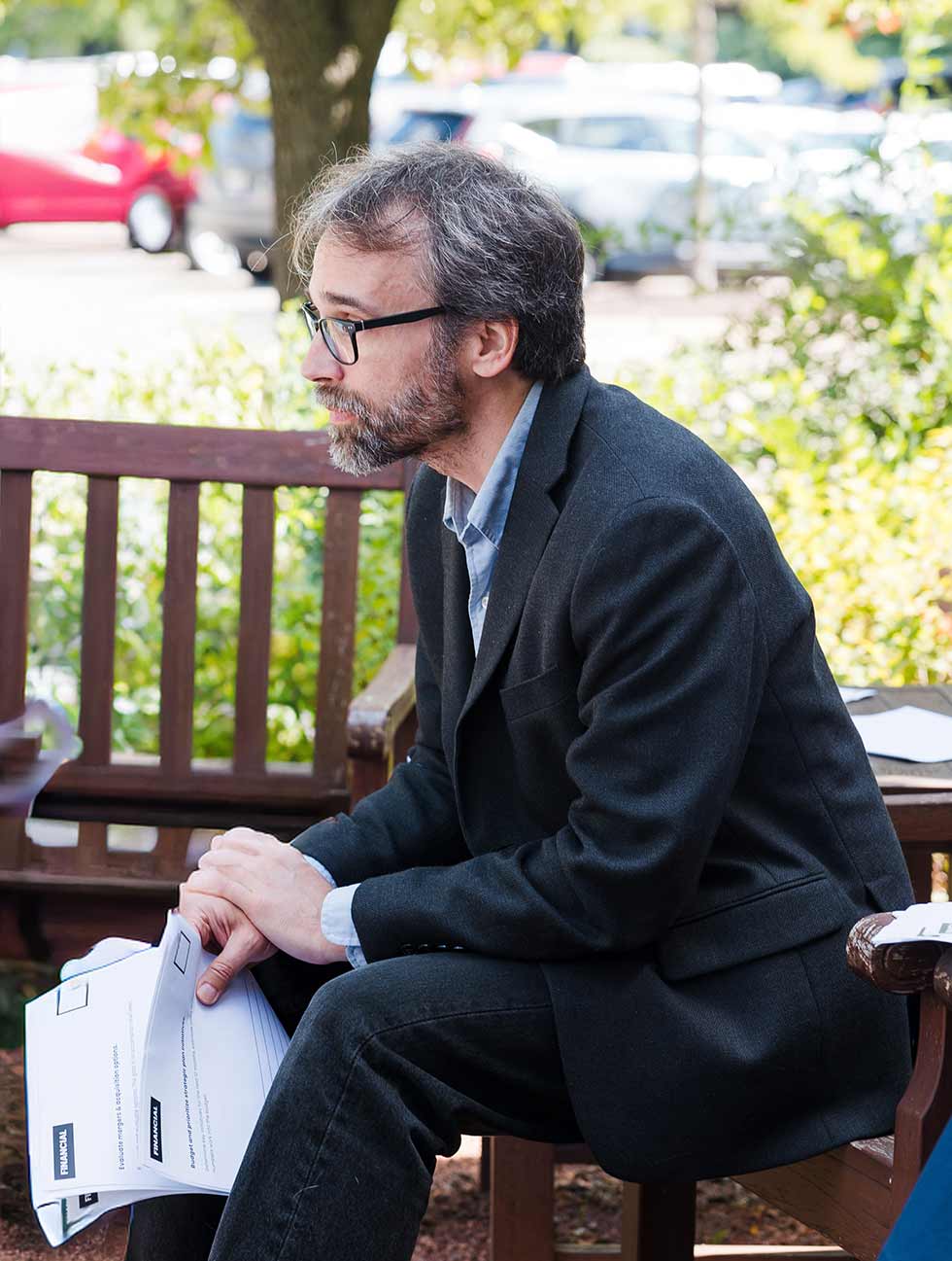 Architect in suit sitting on a bench