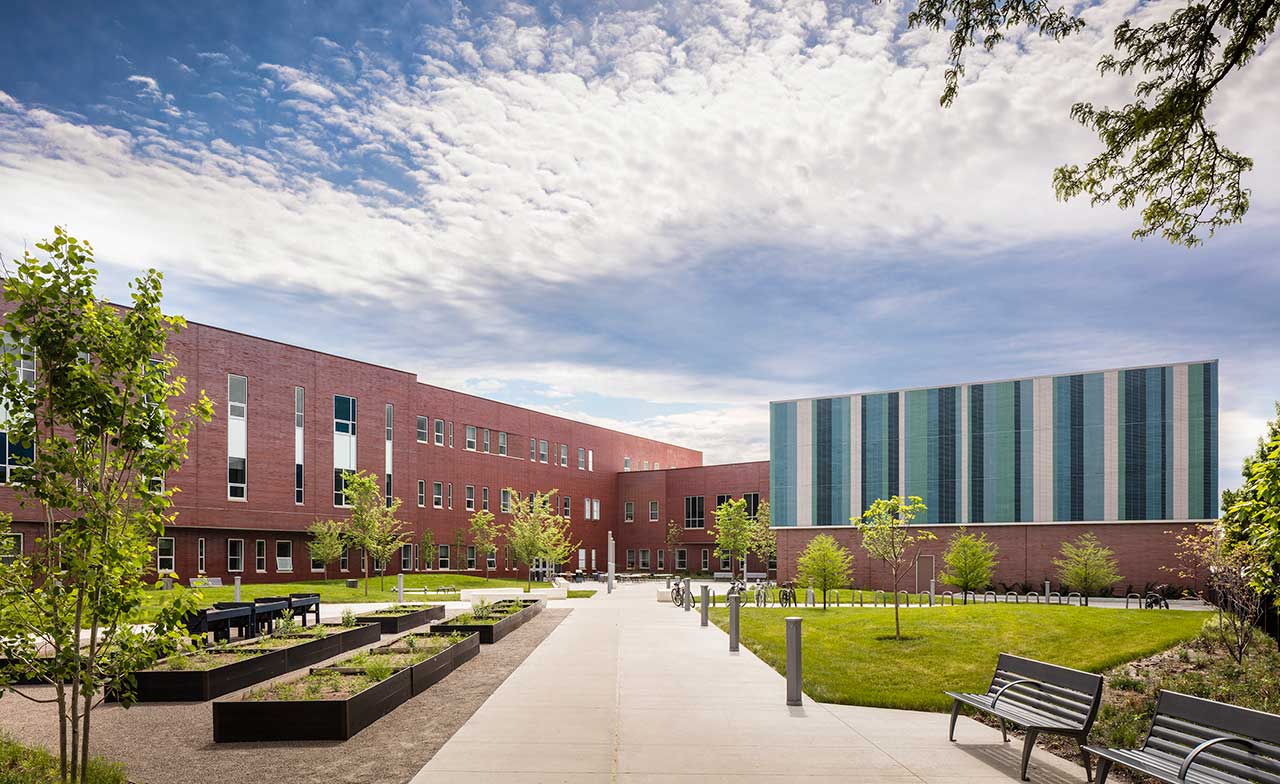 Courtyard and high school with multicolored brick facade