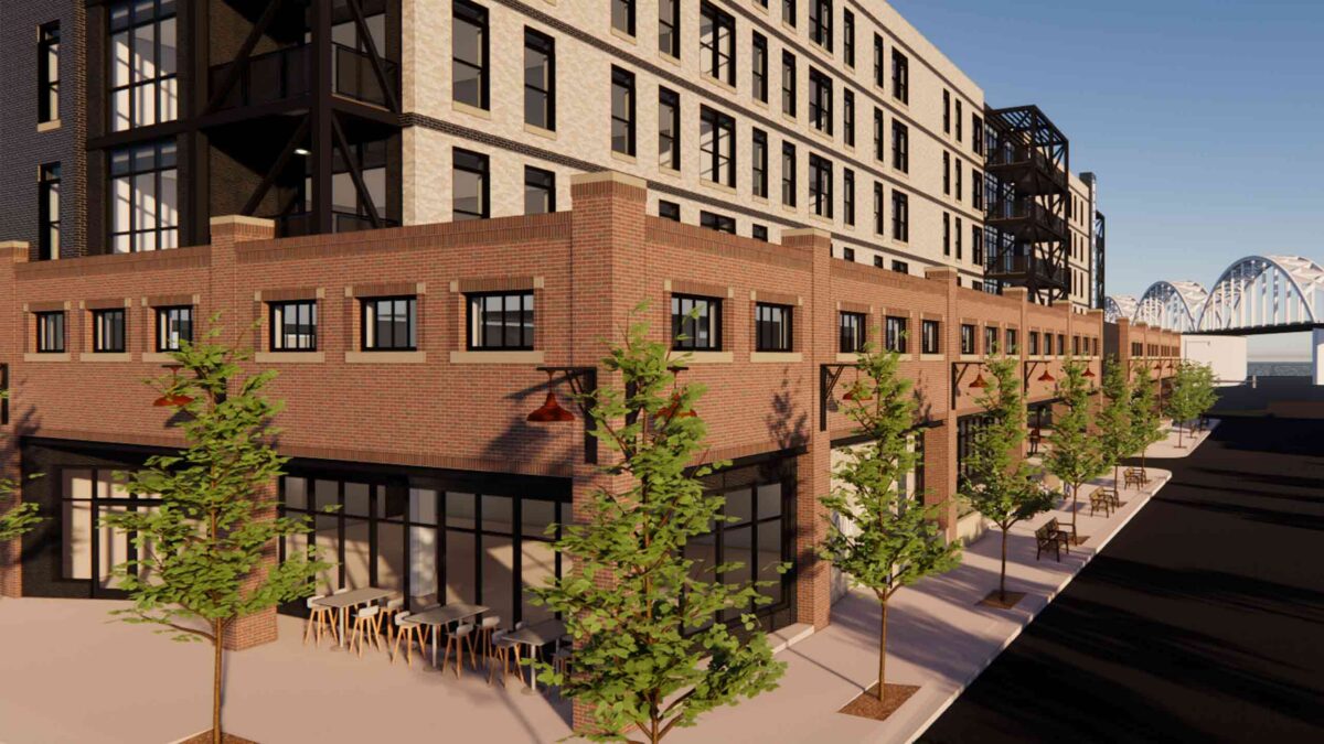 3D architectural rendering of a multi-story brick building with street-level outdoor seating and trees.