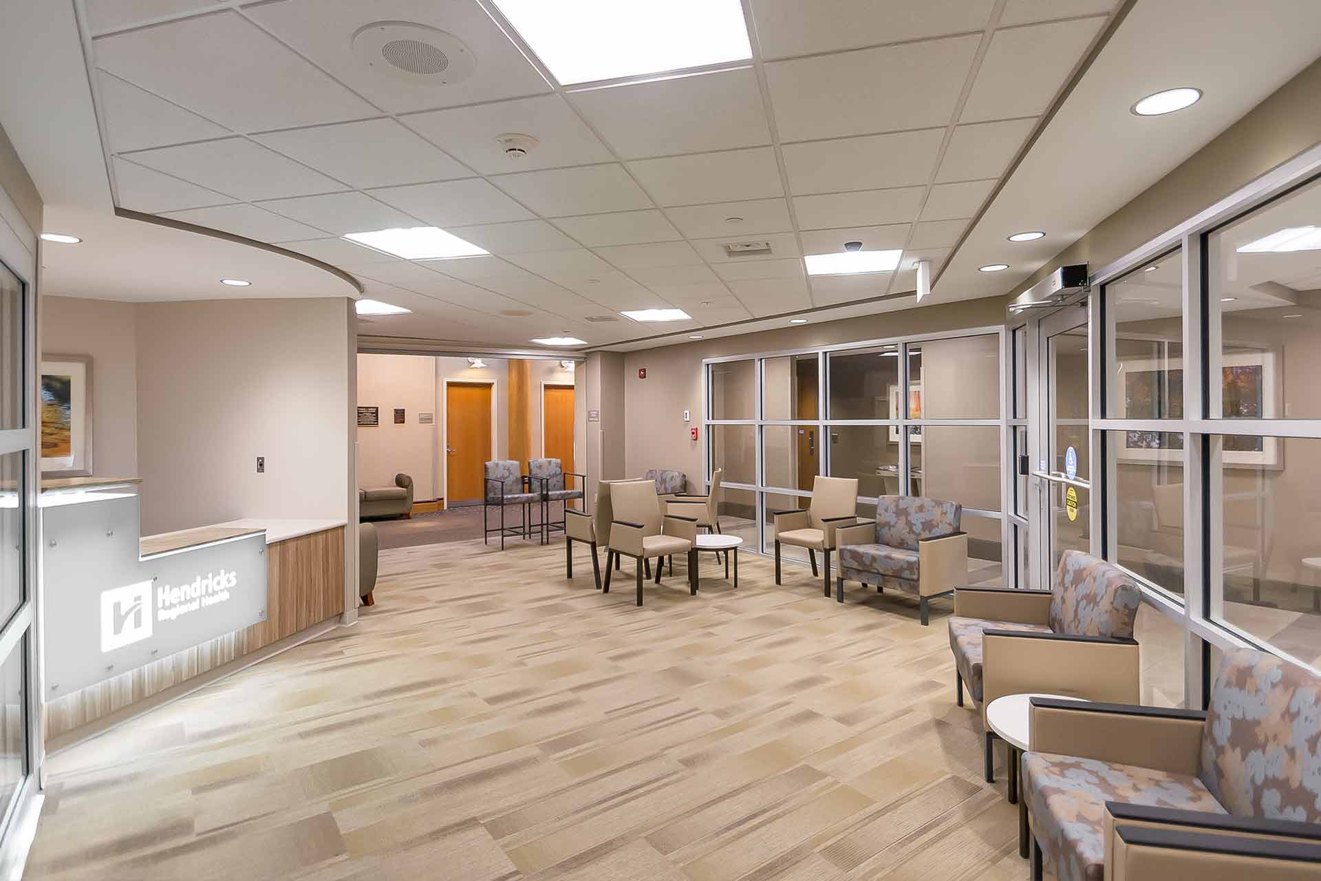 Modern surgical center waiting area with comfortable seating, glass walls, and a bright, welcoming interior.